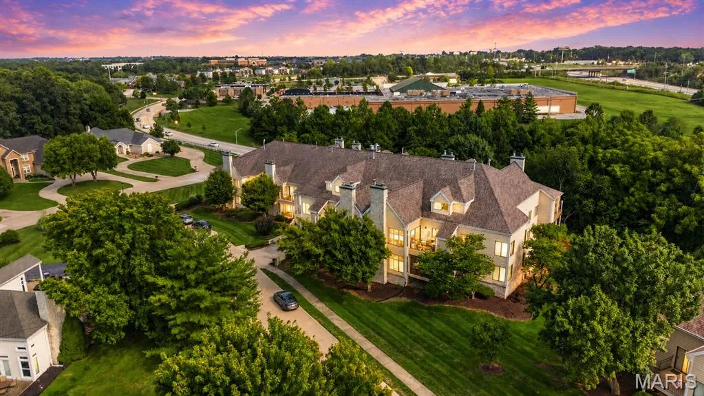 Expansive property featuring a multi-story exterior, multiple gabled rooflines, and dormer windows — 1608 Lake Knoll Drive #1A, Lake St. Louis, MO 63367