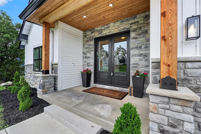 Stone facade with wood beam accents and a wood-paneled porch ceiling — 3 Millers Court, O'Fallon, MO 63366