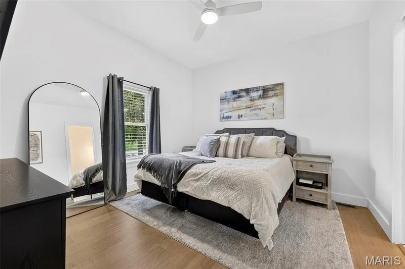 White walls, wood-finish flooring, ceiling fan, and a window with blinds — 3 Millers Court, O'Fallon, MO 63366