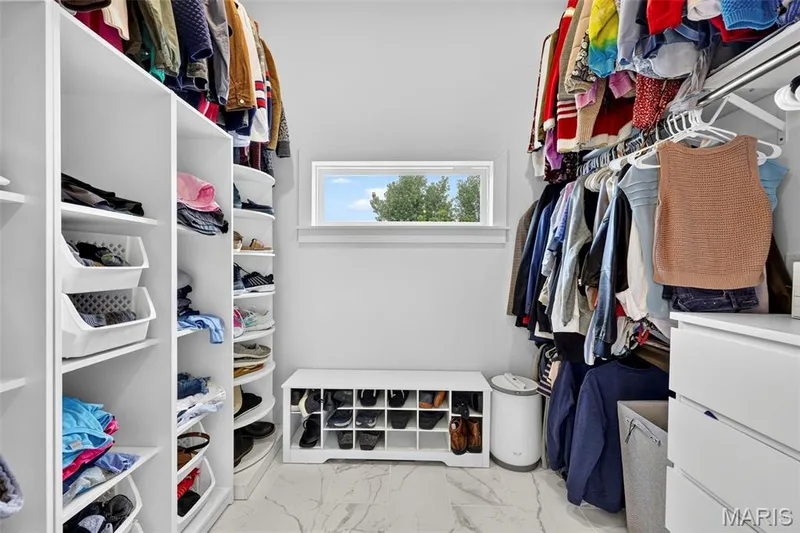Custom closet system featuring built-in shelving, hanging rods, and an integrated shoe organizer — 3 Millers Court, O'Fallon, MO 63366