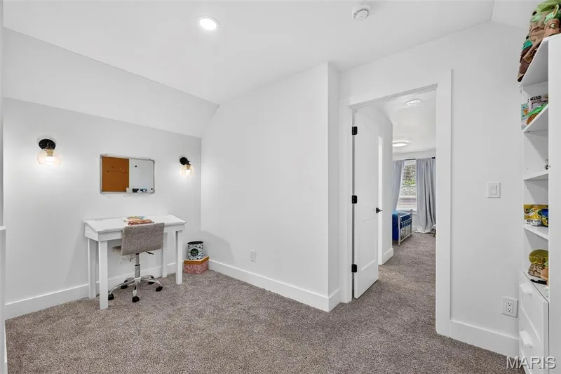 Versatile home office featuring recessed lighting, white painted walls, neutral carpet flooring, and built-in shelving with open storage — 3 Millers Court, O'Fallon, MO 63366