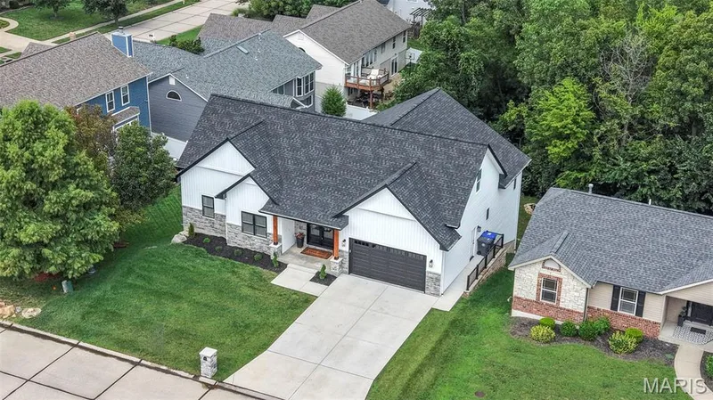 Modern farmhouse exterior with board and batten siding and stone accents — 3 Millers Court, O'Fallon, MO 63366