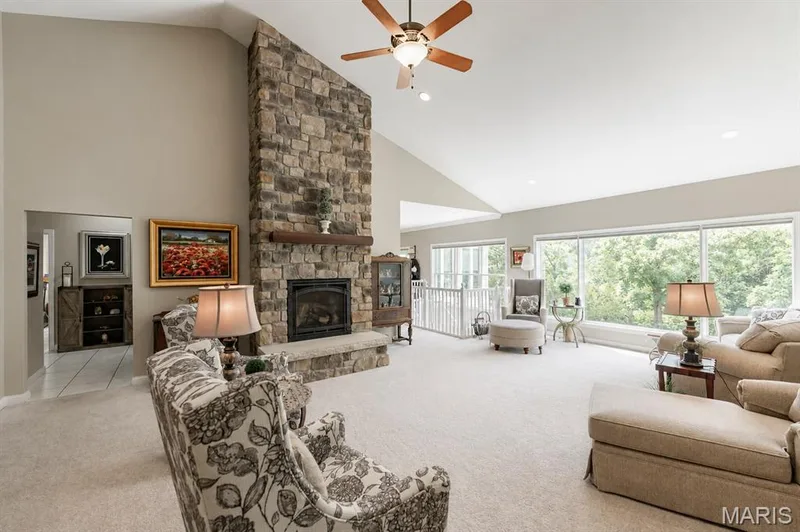 Stunning new gas fireplace and floor to ceiling windows overlooking the water and trees — 4484 Kingfisher Court, Augusta, MO 63332