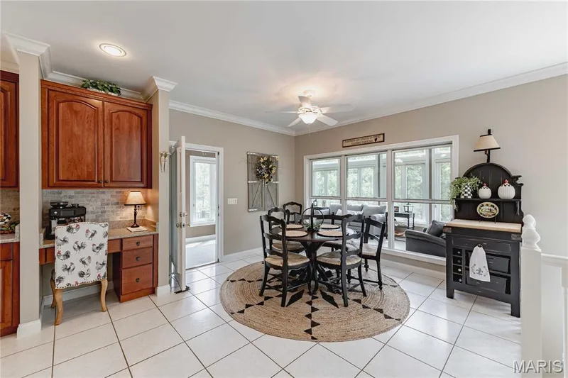 Breakfast area opens onto the massive sunroom and deck beyond. — 4484 Kingfisher Court, Augusta, MO 63332