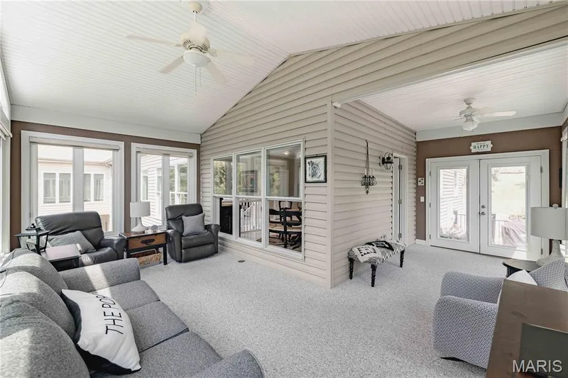 Beautiful sunroom overlooking the lake, double doors onto the large composite deck — 4484 Kingfisher Court, Augusta, MO 63332