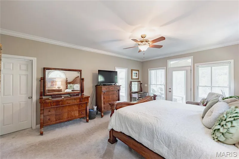 Primary Bedroom with dual walk in closets, private sunporch and ensuite bath — 4484 Kingfisher Court, Augusta, MO 63332