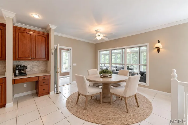 Breakfast area opens onto the massive sunroom and deck beyond. — 4484 Kingfisher Court, Augusta, MO 63332