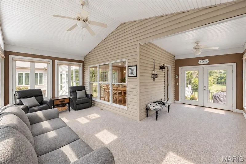 Beautiful sunroom overlooking the lake, double doors onto the new large composite deck — 4484 Kingfisher Court, Augusta, MO 63332