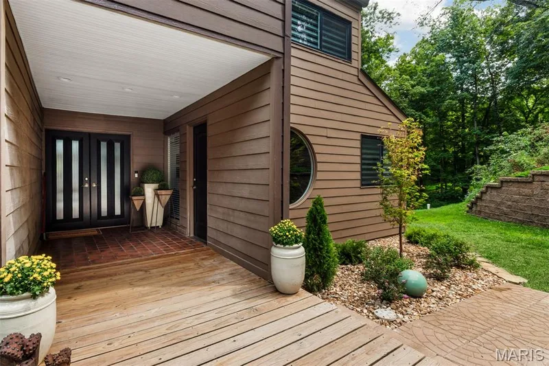 A quiet welcome beneath the trees—the covered front porch sets the tone for what’s inside — 35 Arrowhead Estates Court, Chesterfield, MO 63017