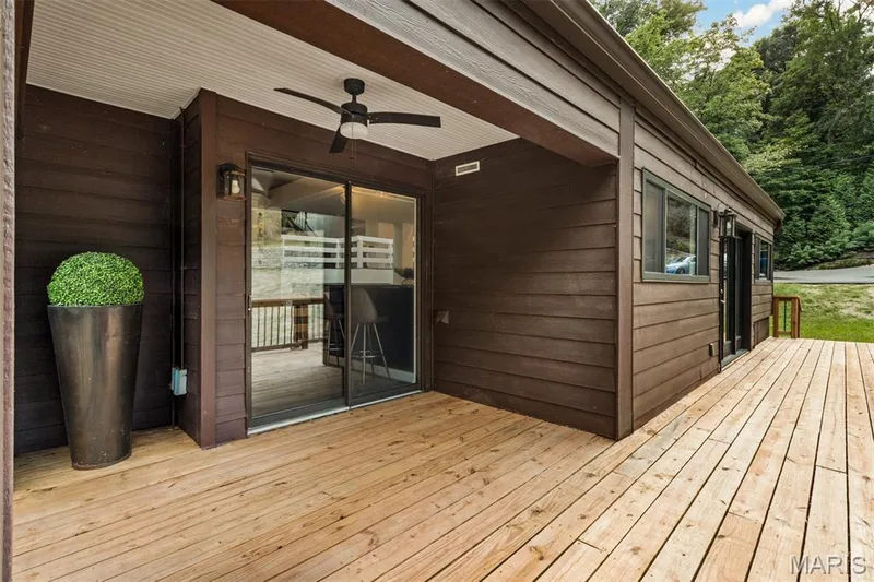 Multiple sliding doors dissolve the boundary between home, decks, woods and water — 35 Arrowhead Estates Court, Chesterfield, MO 63017