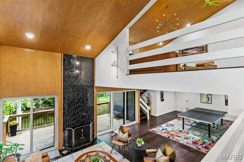 Family room anchored by marble fireplace, sliding glass doors and custom woodwork — 35 Arrowhead Estates Court, Chesterfield, MO 63017
