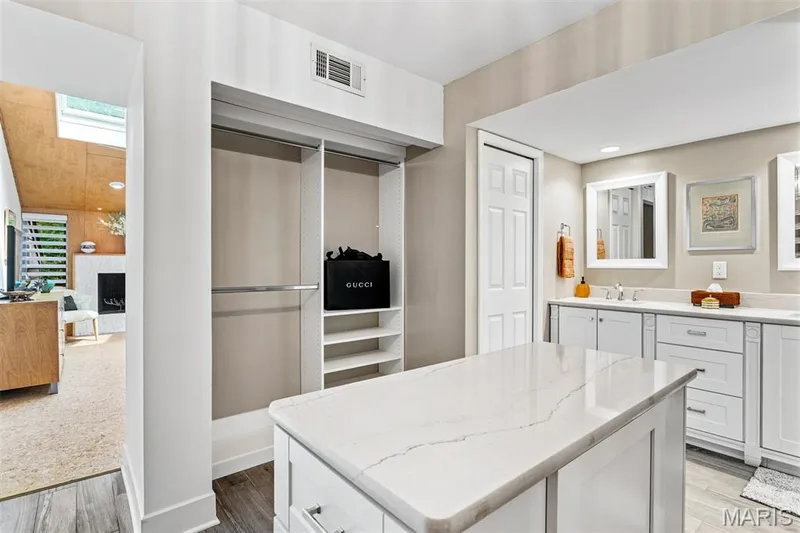 Custom primary closet has island, shelving, drawers and ample space — 35 Arrowhead Estates Court, Chesterfield, MO 63017
