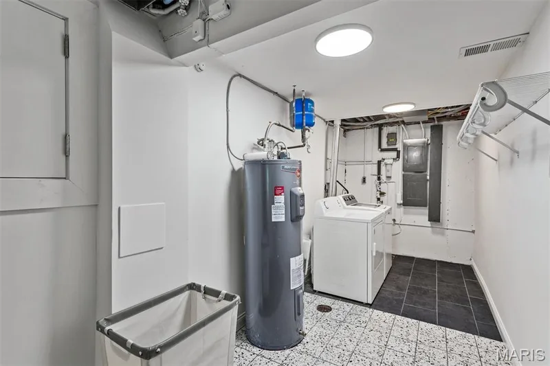 Laundry room shows off new electric panel, water heater, tile, lighting, laundry chute, and crawl space that's fully insulated — 35 Arrowhead Estates Court, Chesterfield, MO 63017