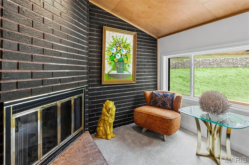 Tucked beside the dining room, the fireside conversation den is made for a book, a glass of wine and the end of the evening. — 35 Arrowhead Estates Court, Chesterfield, MO 63017