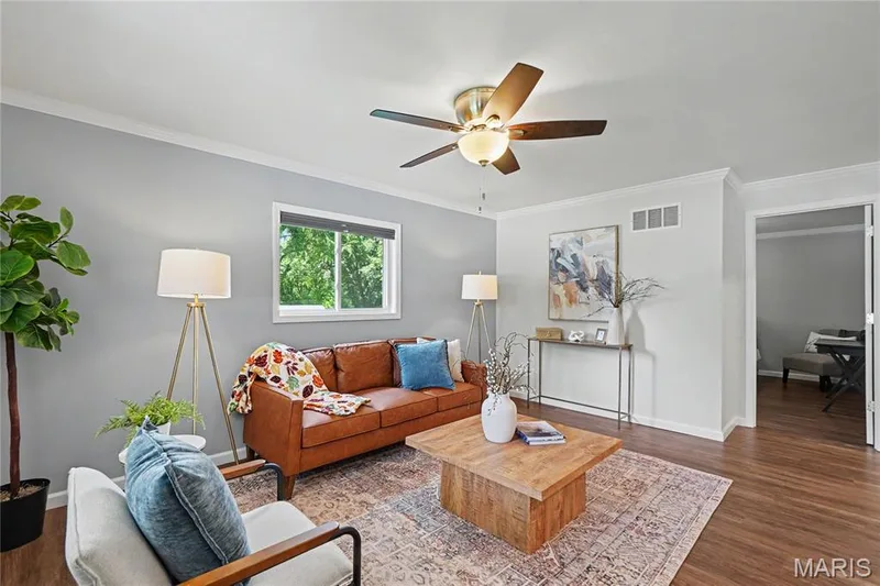 Wood-finish flooring throughout, complemented by crown molding and light gray walls — 31 Plackemeier, O'Fallon, MO 63366