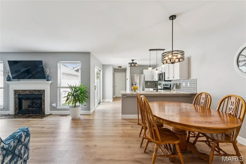 Designed for both everyday living and entertaining, the open-concept main level brings the dining area, kitchen, and living room together seamlessly. Abundant natural light, updated finishes, and a cozy fireplace create a space that feels both polished and inviting. — 947 Rolling Thunder Drive, O'Fallon, MO 63368