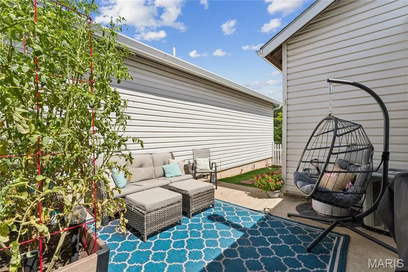 A private outdoor retreat right outside your door. This inviting patio offers plenty of room to relax, garden, or enjoy a quiet morning coffee in the fresh air. — 947 Rolling Thunder Drive, O'Fallon, MO 63368