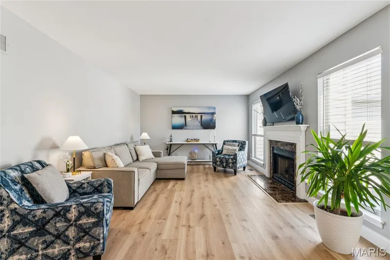Experience the perfect blend of cozy and spacious in this inviting living room, featuring a warm gas fireplace as its focal point. Enjoy natural light and views to the private back patio, offering the perfect backdrop for relaxation or social gatherings. — 947 Rolling Thunder Drive, O'Fallon, MO 63368