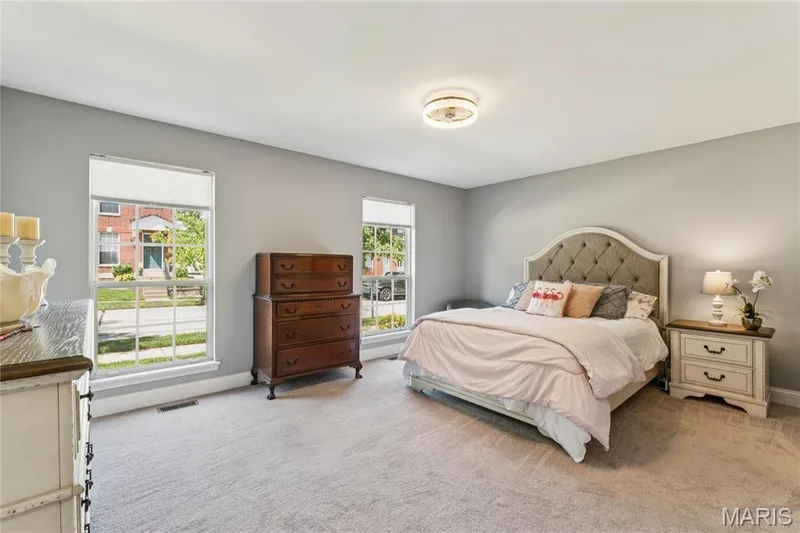 The main-floor primary suite is a standout, offering generous proportions, abundant natural light, and plenty of room to create a comfortable retreat. — 947 Rolling Thunder Drive, O'Fallon, MO 63368