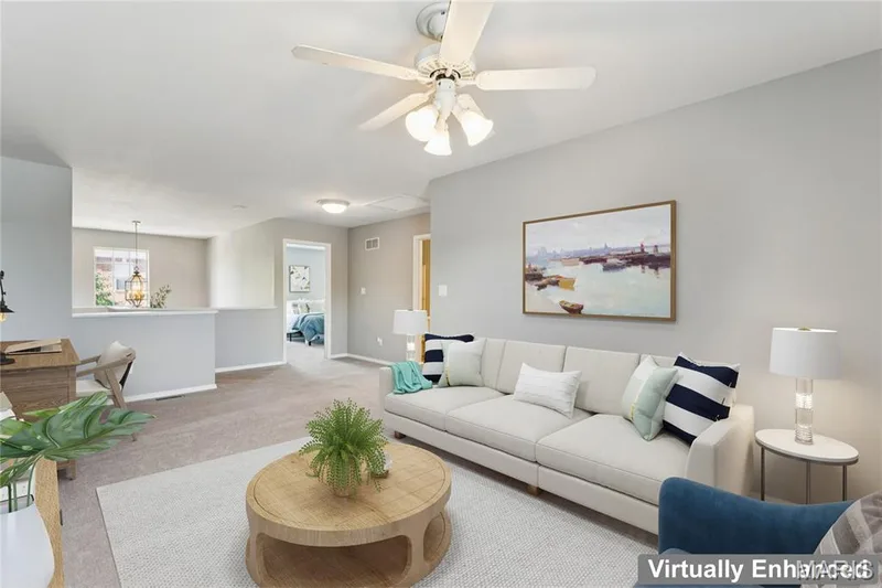 Upstairs, a spacious bonus room offers the perfect blank canvas for however you live. This virtually enhanced view shows the potential for a stylish lounge, complete with a dedicated workspace, cozy seating, and room to spread out, but the possibilities are entirely up to you. From a home office to a media room to a play space, this flexible retreat adapts as your needs change. — 947 Rolling Thunder Drive, O'Fallon, MO 63368