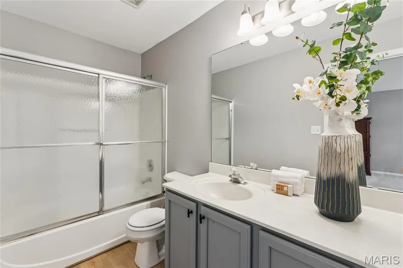 Step into the practical elegance of this full bathroom, complete with a spacious vanity that offers plenty of room to prepare for your day. The large mirror and bright lighting enhance the clean, fresh atmosphere, making morning routines a breeze. — 947 Rolling Thunder Drive, O'Fallon, MO 63368