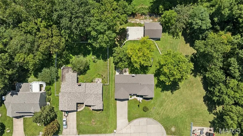 See the full picture: home, shop, and wooded privacy all in one setting. — 416 Loiselaine Drive, O'Fallon, MO 63366