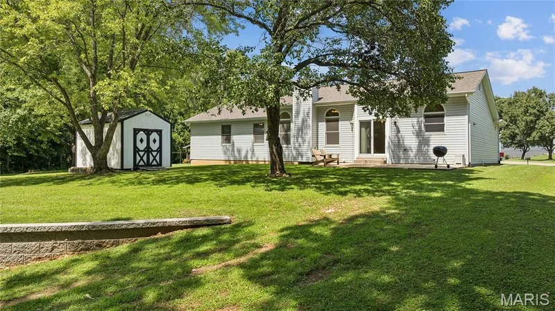 Extra storage meets extra shade, the shed and mature trees make this backyard as functional as it is beautiful. — 416 Loiselaine Drive, O'Fallon, MO 63366