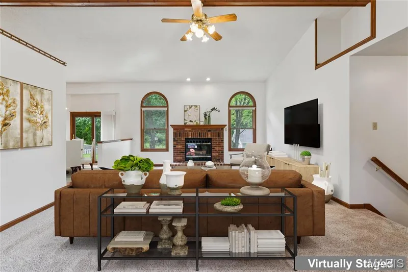 Gather around the brick fireplace on cool evenings, the natural focal point of this open living space. — 416 Loiselaine Drive, O'Fallon, MO 63366