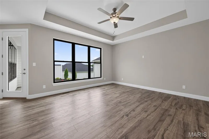 Living Room with Tray Ceiling, Triple Window and Ceiling Fan — 149 Haven Ridge Court, Dardenne Prairie, MO 63368