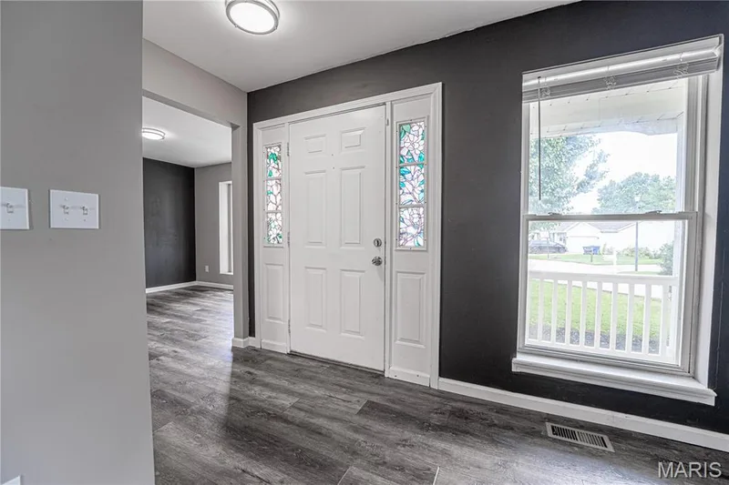 Entryway featuring wood-finish flooring, a front door with decorative glass sidelights, and recessed ceiling lighting — 1721 Summergate Court, St Charles, MO 63303