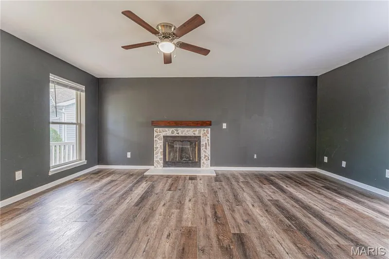 Spacious interior with wood-finish flooring and a ceiling fan — 1721 Summergate Court, St Charles, MO 63303