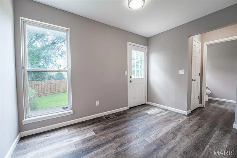 Wood-finish flooring, neutral wall paint, and white trim throughout — 1721 Summergate Court, St Charles, MO 63303