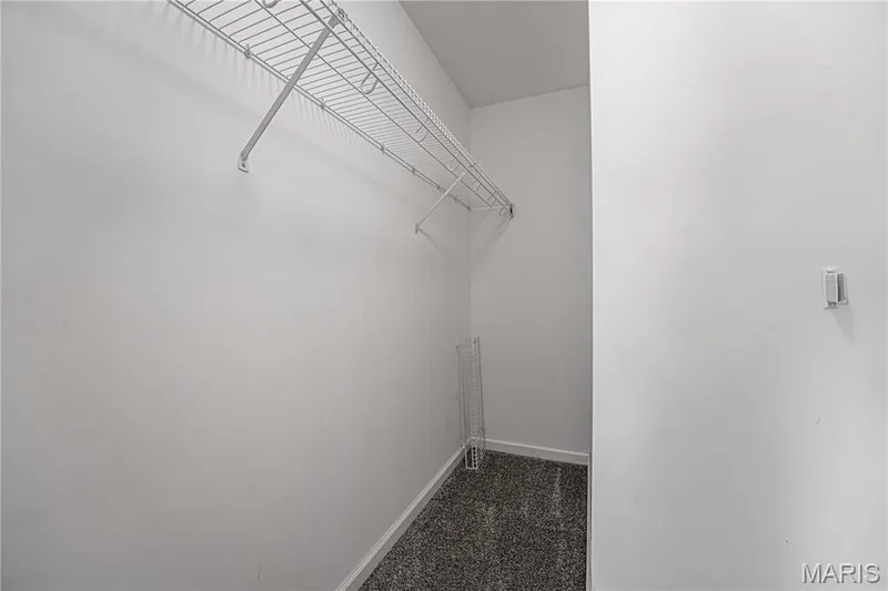 White wire shelving system, light gray wall paint, dark gray carpeting — 1721 Summergate Court, St Charles, MO 63303