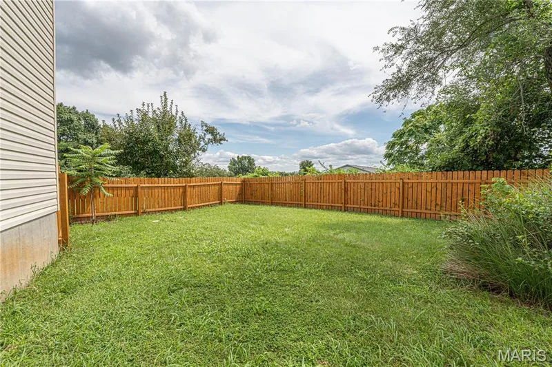 Expansive grassy yard with wood privacy fencing — 1721 Summergate Court, St Charles, MO 63303