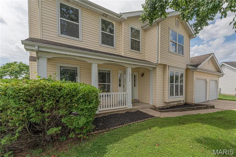 Two-story residence featuring light-colored siding and a covered front porch — 1721 Summergate Court, St Charles, MO 63303