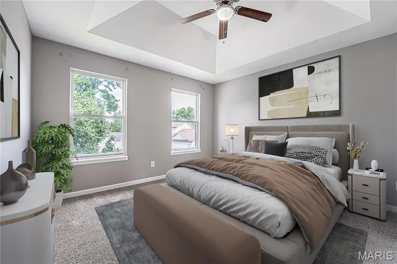Tray ceiling with a ceiling fan, two windows, and textured carpeting — 1721 Summergate Court, St Charles, MO 63303