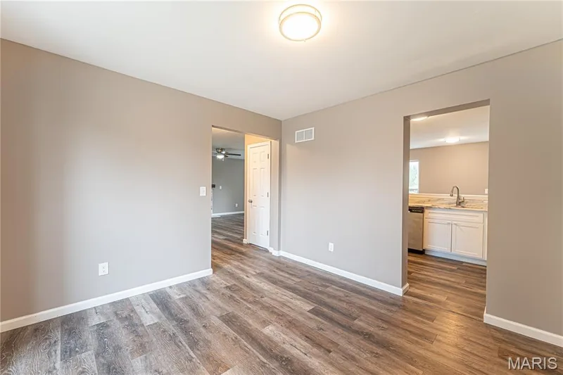 Wood-finish flooring throughout, neutral wall tones, and overhead lighting — 1721 Summergate Court, St Charles, MO 63303