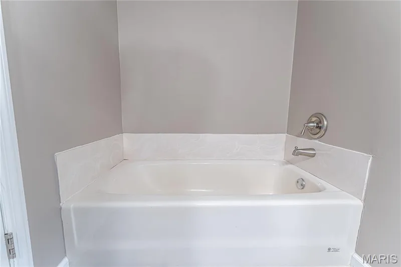 White built-in bathtub with a brushed nickel faucet and control — 1721 Summergate Court, St Charles, MO 63303