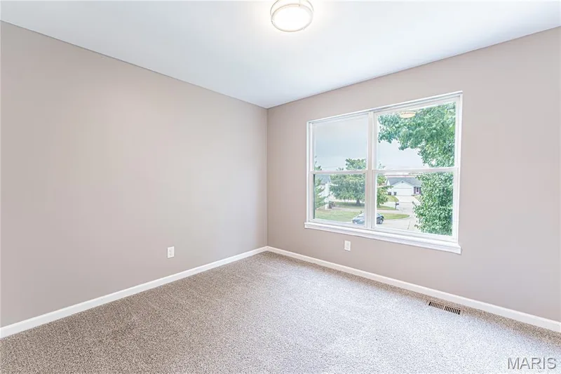 Neutral-toned walls, carpeted flooring, and a flush mount light fixture — 1721 Summergate Court, St Charles, MO 63303