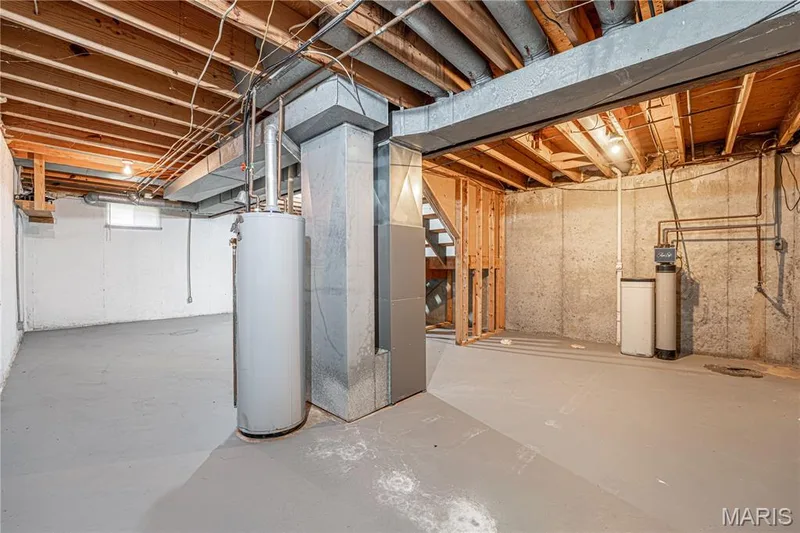 Unfinished basement with concrete walls, exposed ceiling joists, and painted concrete flooring — 1721 Summergate Court, St Charles, MO 63303