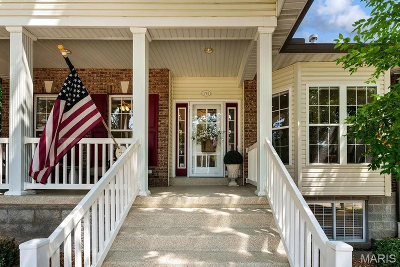 Wide staircase with recent epoxy covering welcomes family and visitors. — 781 Queens Court Place, St Peters, MO 63376