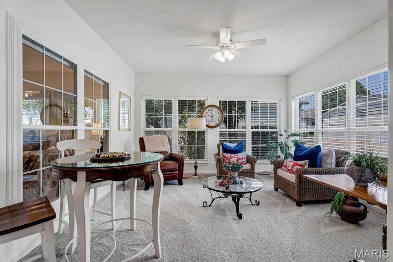 The sunroom addition features LOTS of windows, cushy carpeting and great space for relaxing, chatting with friends or working on a hobby. — 781 Queens Court Place, St Peters, MO 63376