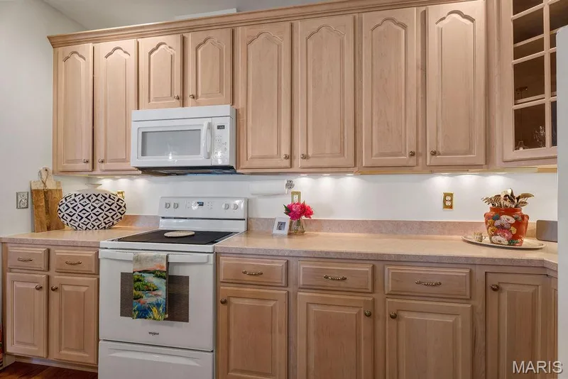 42" cabinets with a staggered corner display cabinet to showcase special pieces or china. — 781 Queens Court Place, St Peters, MO 63376