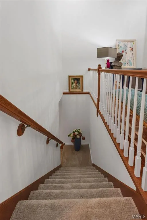 Spindled railing from the great room leads to the finished lower level. — 781 Queens Court Place, St Peters, MO 63376
