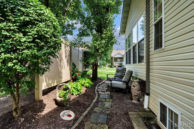 Seller created this cozy and comfortable sitting space behind the sunroom. It's a great spot for coffee or a relaxing book. — 781 Queens Court Place, St Peters, MO 63376