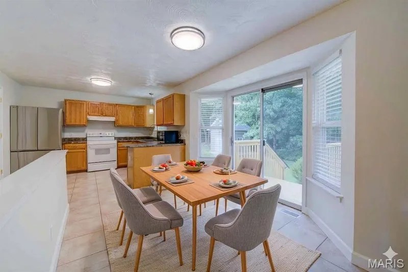 Virtually staged - Breakfast Room with Bay Window and Sliding Glass Door to Back Patio — 868 Molloy Drive, O'Fallon, MO 63366