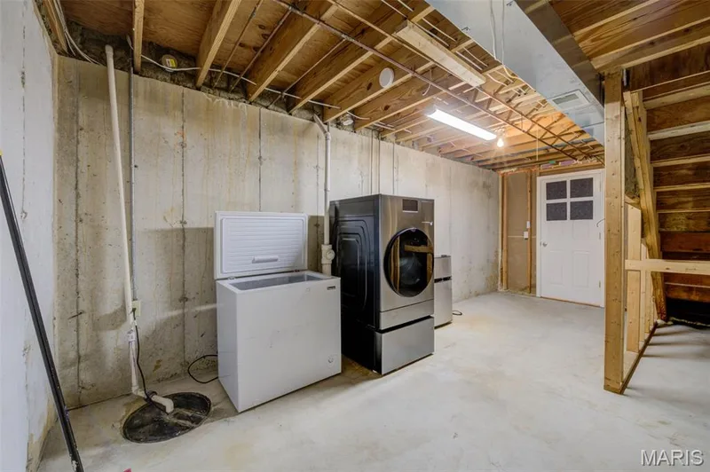 Lower Level Laundry Area with Sump Pit and Pump — 868 Molloy Drive, O'Fallon, MO 63366