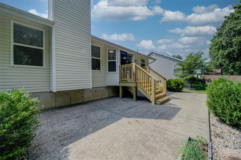 New Elevated Wood Landing with Steps from Breakfast Room Slider to Aggregate Patio — 868 Molloy Drive, O'Fallon, MO 63366