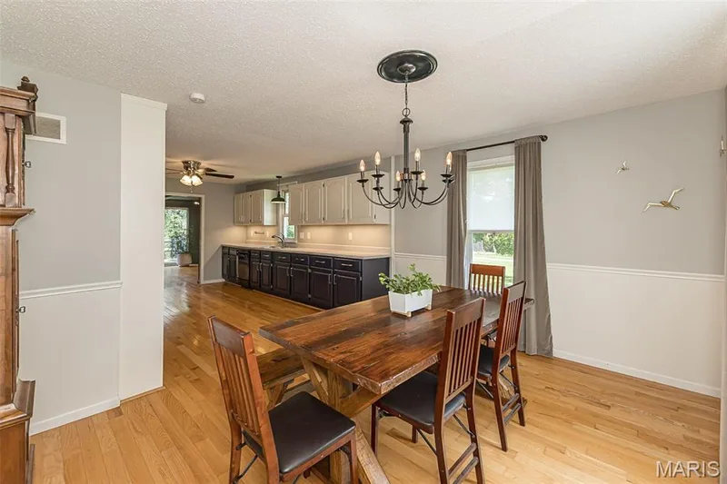 Breakfast room is very large with chair rail and wood floors — 17723 Mueller Road, Wildwood, MO 63038