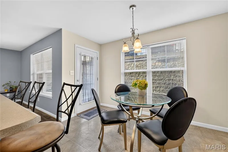 Recessed lighting, tiled flooring, pendant light fixture, multiple windows with blinds, and an exterior door — 313 Bramblett Hills, O'Fallon, MO 63366